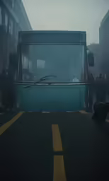 a large bus with its lights on is stopped in a traffic circle