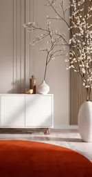 the modern decor features a white cabinet and round vases