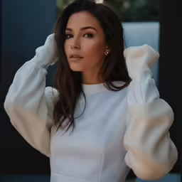 a woman is looking at the camera and posing for a picture