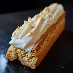 a close up shot of a dessert item on a black counter