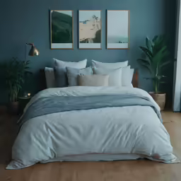 large white and blue bedspread on wooden floor in green room