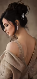 a woman wearing a very pretty dress with a long dress on