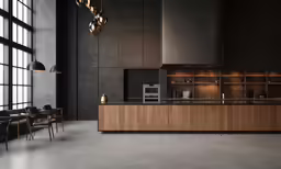 an empty modern looking kitchen with windows