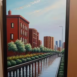 a painting of a city scene hangs on a wall