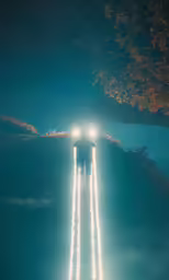 an airplane is flying through the air over a night sky
