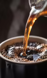 the coffee is being poured into a cup