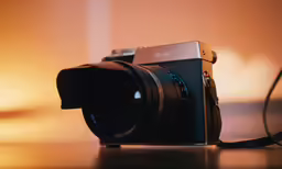 a camera sitting on top of a table with a wire next to it
