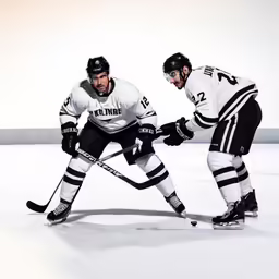 two men are skating together in the rink