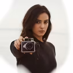 a woman holding a camera up to her face