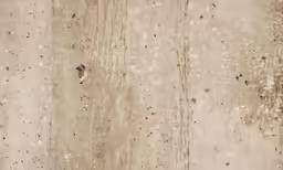 a man walks past a puddle in the mud