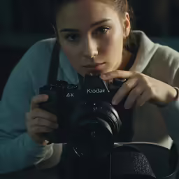 a woman holding a camera takes a picture