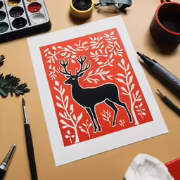 a workbook with paper cut art featuring a deer