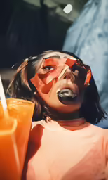 a woman is holding a drink in her hand