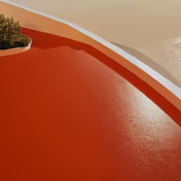 an orange, curved wall is near the sand