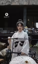 a woman in kimono stands in front of an object