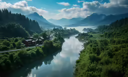 some buildings on the shore next to a river and a mountain