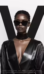 a woman with a black outfit and sunglasses on
