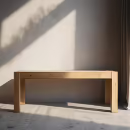 a long wooden bench sits in an empty room