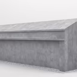 there is a concrete structure and the wall has gravel around it