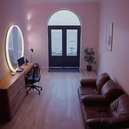 the room has a leather couch and table