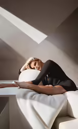 a model lays down on the bed in black