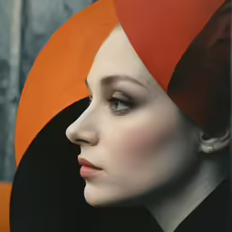 a woman with a black top and a red and orange hair