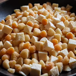 cut pieces of food cooking in a bowl