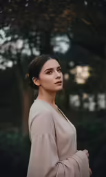a young woman wearing a dress in a forest