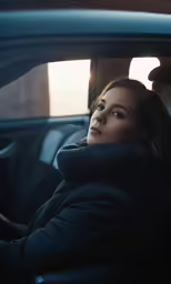 a woman sitting in a car is looking off to her left