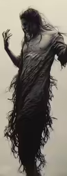 a woman is dressed in black standing against the sky