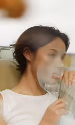 a woman looks at herself through a large circular lens
