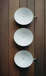 two bowls are hanging on a wall