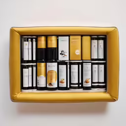 the wine collection is organized in a golden box