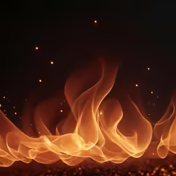 a group of flames burning over a black background