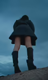 woman in a dark coat and black boots