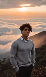 a man standing on top of a hill covered in fog
