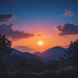 a sunrise over a mountain with some clouds