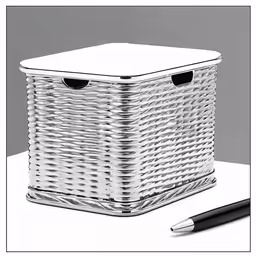the white wicker basket has black trim and a pen beside it