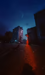 a building lit up with neon lights and red streaks