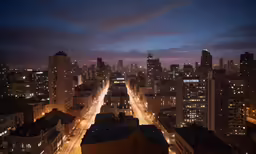 this is a view of a city at night from the top of a building