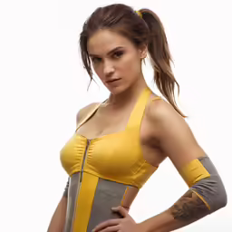 a woman posing with a yellow top and grey pants