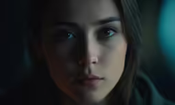 an intense close - up of a woman staring into the camera