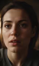 a woman looking to her left with a serious look on her face