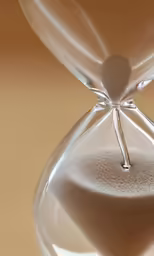 a hourglass is sand flowing through the middle