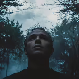 the man looks like he is in front of the trees