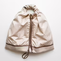 a satine bag is seen here against a white background