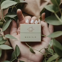 a person is holding onto some leafy branches and holding a small lighter
