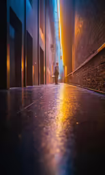 the dark alley way with a person walking on the sidewalk