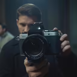 a man in the dark taking a picture with his camera