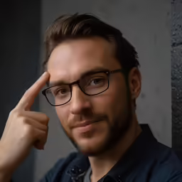 a close up of a person wearing glasses and a black shirt